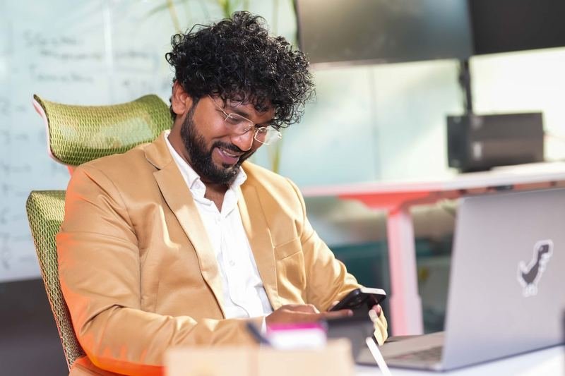 Developer smiling at his phone